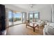 Bright living room with water views, hardwood floors, and ample natural light at 5450 Eagles Point Cir # 405, Sarasota, FL 34231