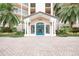 Condo building entrance with teal doors and landscaped grounds at 5450 Eagles Point Cir # 405, Sarasota, FL 34231