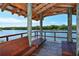 Relaxing waterfront gazebo with wooden benches at 5450 Eagles Point Cir # 405, Sarasota, FL 34231