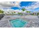 Pool and spa area with lounge chairs and palm trees at 5514 Tidal Breeze Cv, Bradenton, FL 34211