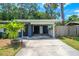 Navy blue house exterior with carport and tropical landscaping at 560 Bradenton Rd, Venice, FL 34293