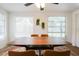 Dining room with wood table and chairs, large windows and decorative wall hangings at 560 Bradenton Rd, Venice, FL 34293