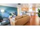 Tan leather couches and a view into the kitchen from the living room at 560 Bradenton Rd, Venice, FL 34293