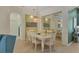 Dining room with white table and chairs, mirror accent wall at 6927 Lennox Pl, University Park, FL 34201