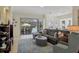 Living room with sectional sofa, rug, and pool view at 6927 Lennox Pl, University Park, FL 34201