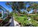 Landscaped backyard with stone pathway and lush greenery at 7917 Broadmoor Pines Blvd, Sarasota, FL 34243