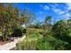 Lush landscaping with stone pathways and mature trees at 7917 Broadmoor Pines Blvd, Sarasota, FL 34243