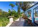 Landscaped backyard with stone pathway and lush greenery at 7917 Broadmoor Pines Blvd, Sarasota, FL 34243