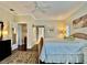 Spacious primary bedroom with large bed, ceiling fan, and access to ensuite bathroom at 7917 Broadmoor Pines Blvd, Sarasota, FL 34243