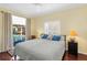 Bedroom with a queen-size bed and pool view at 7917 Broadmoor Pines Blvd, Sarasota, FL 34243