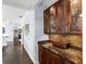 Butlers pantry with granite countertop and glass-front cabinets at 7917 Broadmoor Pines Blvd, Sarasota, FL 34243