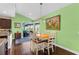 Bright dining area with light wood table and chairs, view of pool at 7917 Broadmoor Pines Blvd, Sarasota, FL 34243