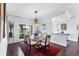 Formal dining room with glass table, hardwood floors, and large window at 7917 Broadmoor Pines Blvd, Sarasota, FL 34243