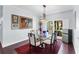 Elegant dining room with a large painting and hardwood floors at 7917 Broadmoor Pines Blvd, Sarasota, FL 34243