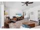 Living room with hardwood floors, built-in shelving and view of dining area at 7917 Broadmoor Pines Blvd, Sarasota, FL 34243