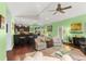 Spacious living room with hardwood floors, ceiling fan, and view of kitchen at 7917 Broadmoor Pines Blvd, Sarasota, FL 34243