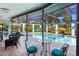 Inviting pool and spa with covered patio seating at 7917 Broadmoor Pines Blvd, Sarasota, FL 34243