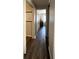 Long hallway with dark wood laminate flooring at 8 White Oak Ter, Sarasota, FL 34237