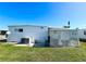 White single-wide mobile home with a covered patio at 8 White Oak Ter, Sarasota, FL 34237