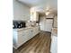 Bright kitchen featuring white cabinets and granite countertops at 8 White Oak Ter, Sarasota, FL 34237