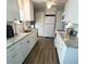 Modern kitchen featuring white cabinets and granite countertops at 8 White Oak Ter, Sarasota, FL 34237