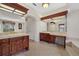 Primary bathroom with dual vanities, tile floors, and a large mirror at 8128 Collingwood Ct, University Park, FL 34201