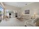 Living room with entertainment center, large windows, and views of the pool area at 8128 Collingwood Ct, University Park, FL 34201