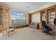 Home office featuring built-in bookshelves, a ceiling fan, and a couch at 8128 Collingwood Ct, University Park, FL 34201