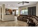 Living room with sectional sofa and view into kitchen at 8277 Villa Grande Ct, Sarasota, FL 34243