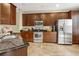 Spacious kitchen with stainless steel appliances and dark wood cabinets at 8277 Villa Grande Ct, Sarasota, FL 34243