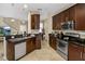 Kitchen with an island, stainless steel appliances, and dark wood cabinets at 8277 Villa Grande Ct, Sarasota, FL 34243