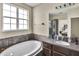 Bathroom features garden tub, vanity, and view of bedroom at 8277 Villa Grande Ct, Sarasota, FL 34243
