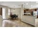 Bright dining area with kitchen access and view into living room at 8277 Villa Grande Ct, Sarasota, FL 34243