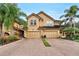 Two-story townhome with double garage and brick driveway at 8277 Villa Grande Ct, Sarasota, FL 34243