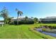 Landscaped backyard with pond view and privacy at 8908 Grey Oaks Ave, Sarasota, FL 34238