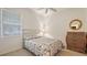 Charming bedroom with a full-size bed and dresser at 9506 Royal Calcutta Pl, Lakewood Ranch, FL 34202