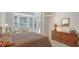 Bright bedroom with striped bedding, dresser and bay window at 9506 Royal Calcutta Pl, Lakewood Ranch, FL 34202