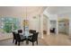 Bright dining room featuring a glass table, chandelier, and view to entryway at 9506 Royal Calcutta Pl, Lakewood Ranch, FL 34202