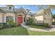 One-story house with red door, stone accents, and well-manicured landscaping at 9506 Royal Calcutta Pl, Lakewood Ranch, FL 34202