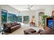 Spacious Gathering room featuring leather furniture and access to a screened patio at 9506 Royal Calcutta Pl, Lakewood Ranch, FL 34202