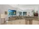 Kitchen features granite countertops, white cabinets, and a view of the pool and lanai at 9506 Royal Calcutta Pl, Lakewood Ranch, FL 34202