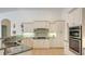Bright kitchen boasts granite countertops, white cabinets, and stainless steel appliances at 9506 Royal Calcutta Pl, Lakewood Ranch, FL 34202