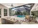 Relaxing screened pool area with patio furniture, offering ample space for outdoor entertainment at 9506 Royal Calcutta Pl, Lakewood Ranch, FL 34202