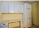 Bright laundry room with built-in cabinetry, counter space, and storage at 960 Cooper St # 402, Venice, FL 34285