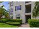 Condo building entrance with stone accents and neatly trimmed landscaping at 1010 Tidewater Shores Loop # 201, Bradenton, FL 34208