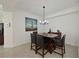 A dining room featuring a table with dark wood and black leather chairs at 1010 Tidewater Shores Loop # 201, Bradenton, FL 34208