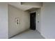 Exterior entryway featuring unit front door, exterior lighting, and fire extinguisher at 1010 Tidewater Shores Loop # 201, Bradenton, FL 34208
