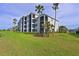 Three-story condo building with balconies and lush landscaping at 1010 Tidewater Shores Loop # 201, Bradenton, FL 34208