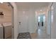 Hallway with tile floors and access to laundry and bedroom at 1010 Tidewater Shores Loop # 201, Bradenton, FL 34208