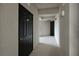 Hallway view featuring unit front door and exterior lighting at 1010 Tidewater Shores Loop # 201, Bradenton, FL 34208